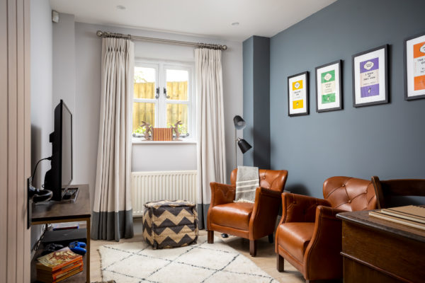 leather armchairs in a cosy TV room with Berber rug