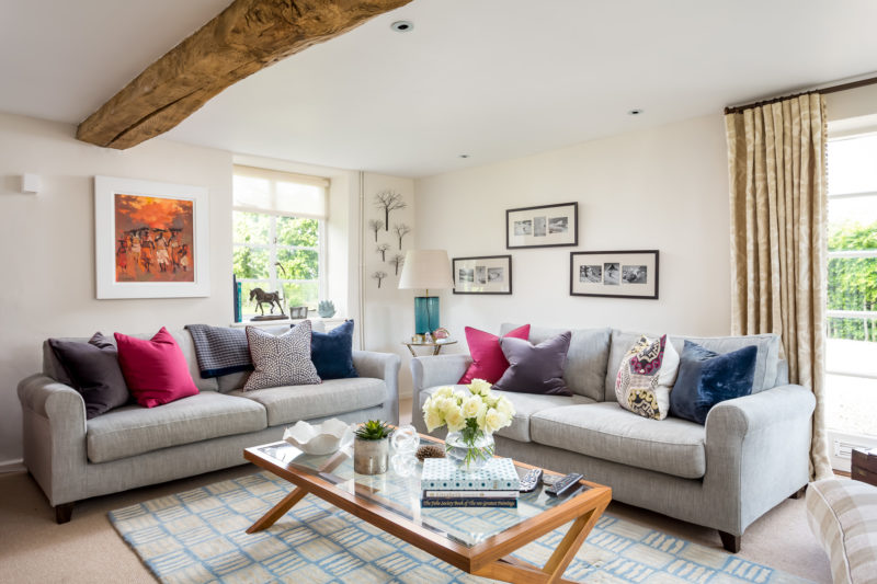 cushions on a corner sofa with rug and coffee table