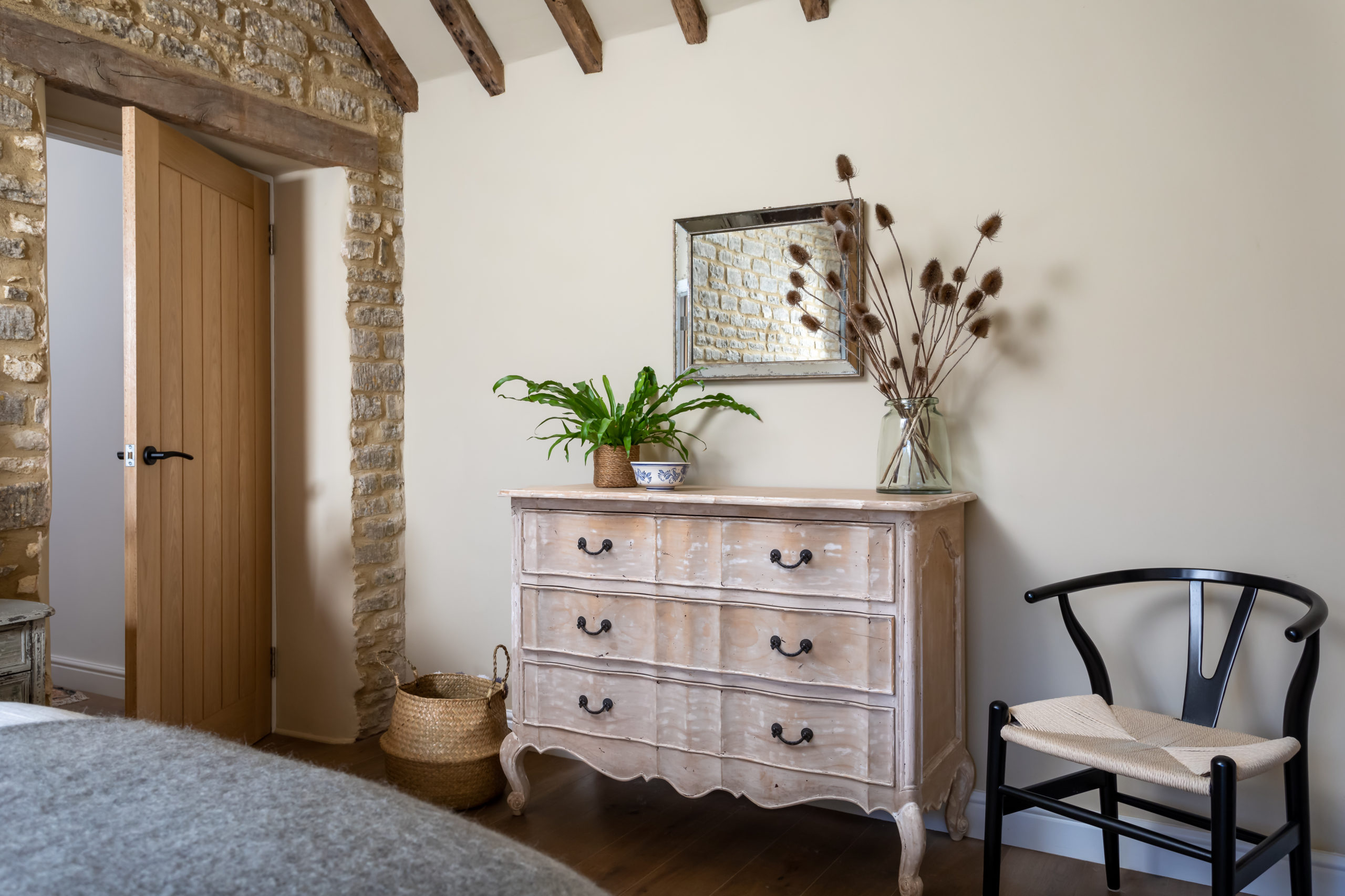 Gustavian style wood chest of drawers in bedroom.