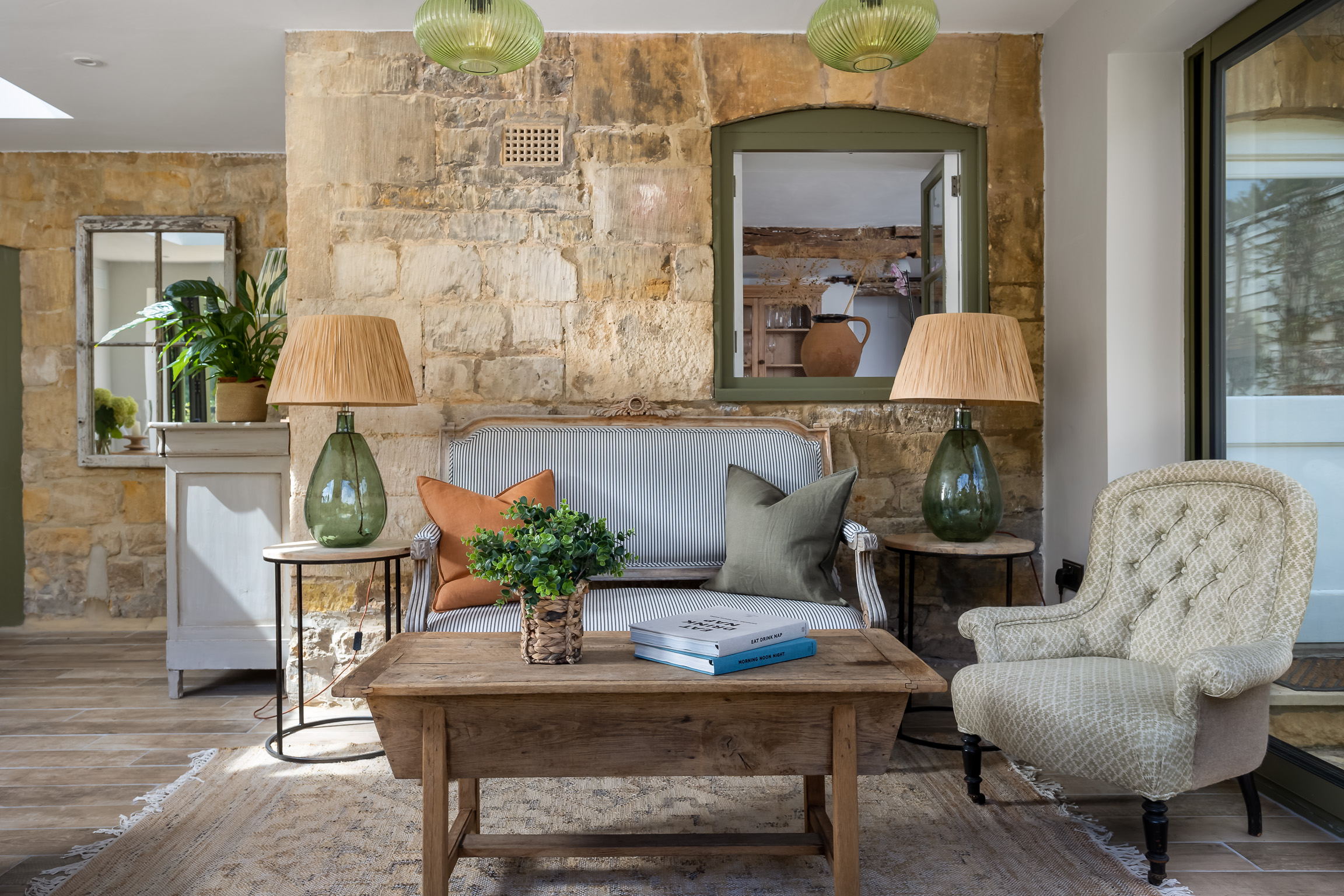 Garden room in French country style with table lamp, sofa, wood coffee table