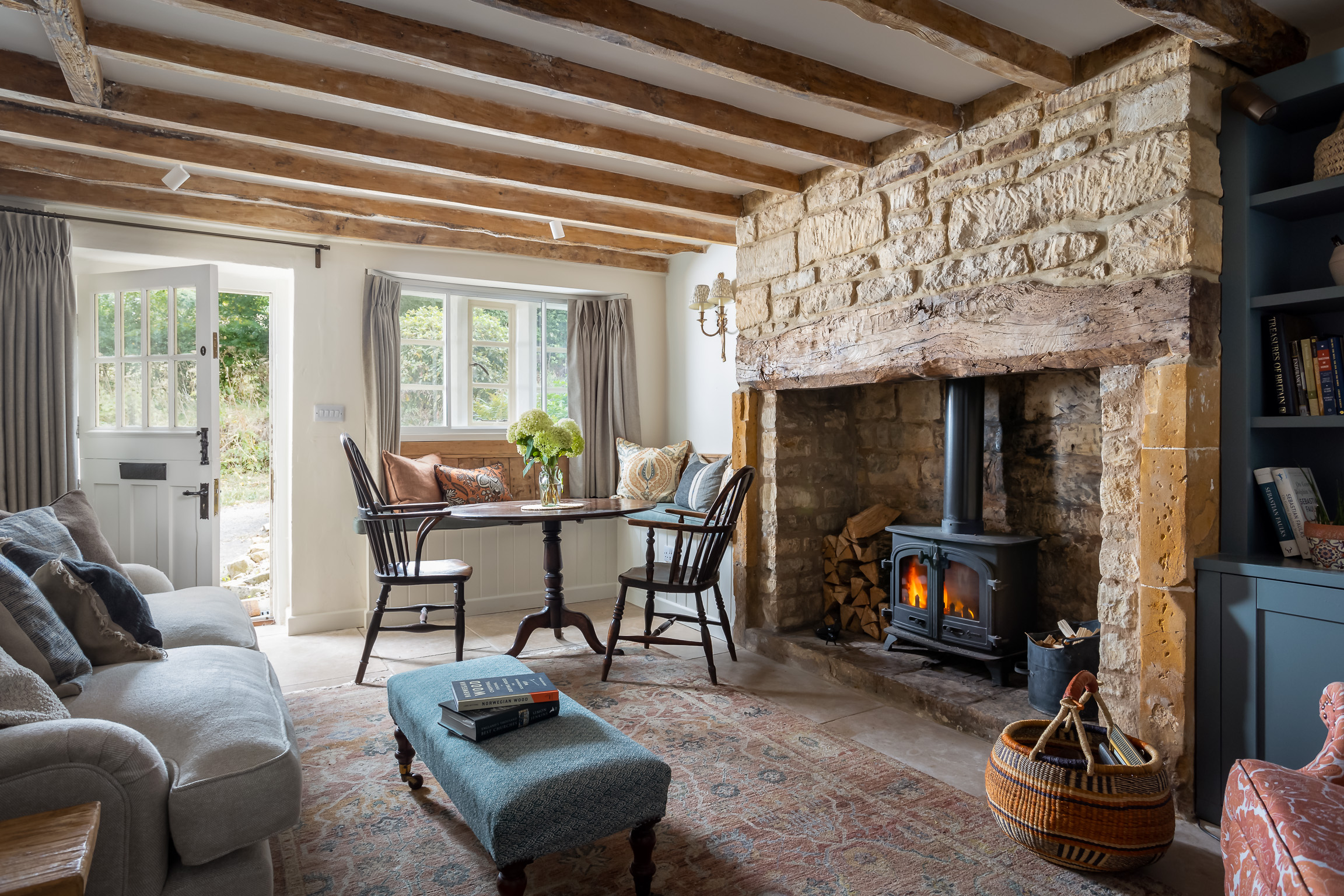 Natural Cotswold stone & wood in living room with inglenook fireplace