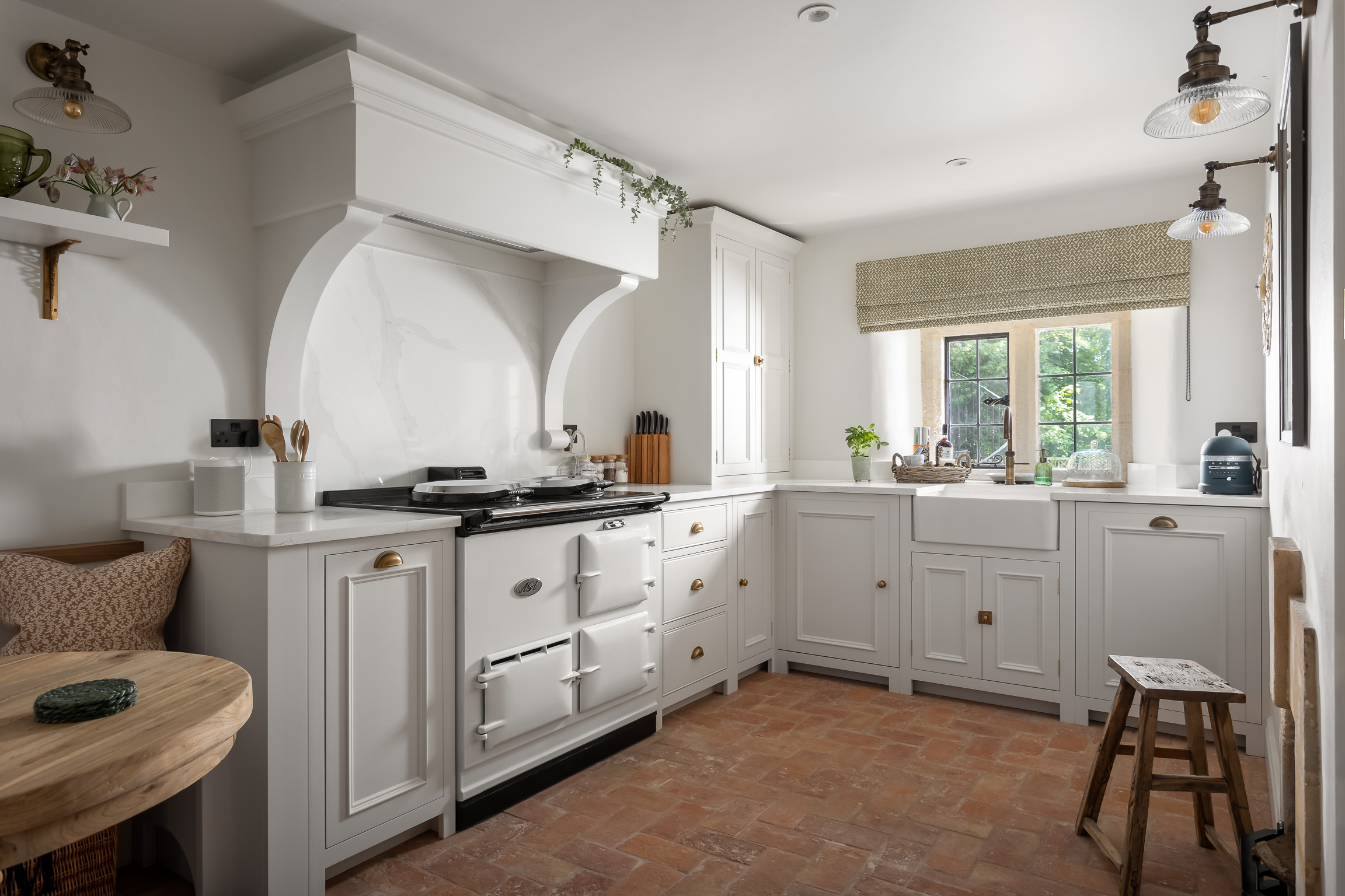 Neptune kitchen; White Aga; herringbone tiled terracotta floor.