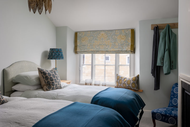 Twin bedroom in teal & lime green. Roman blinds from Lewis & Wood, wood bed throws, Oka cushions