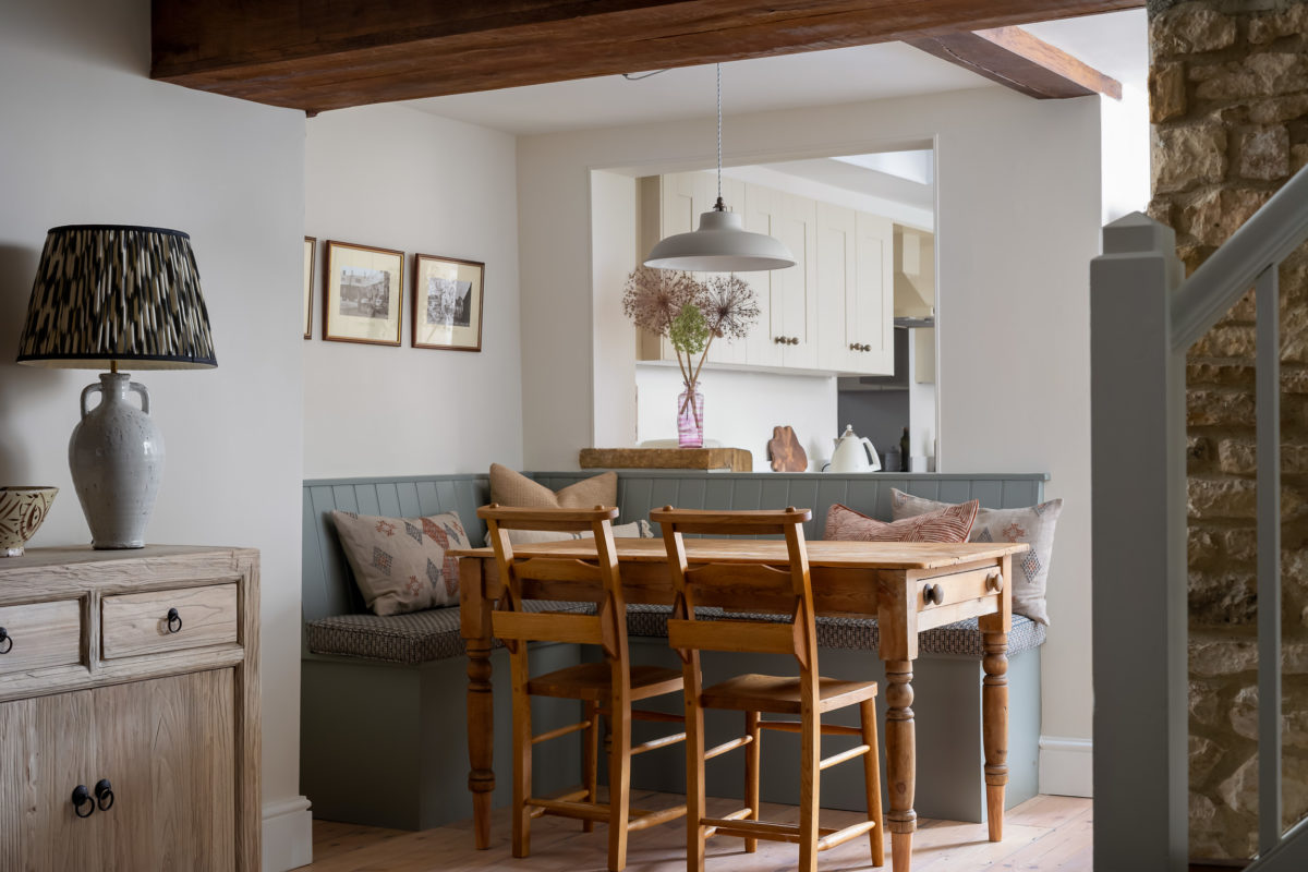 Dining nook with built in bench seat, small pine dining table, pendant light. Sideboard & lamp from dining room adjacent