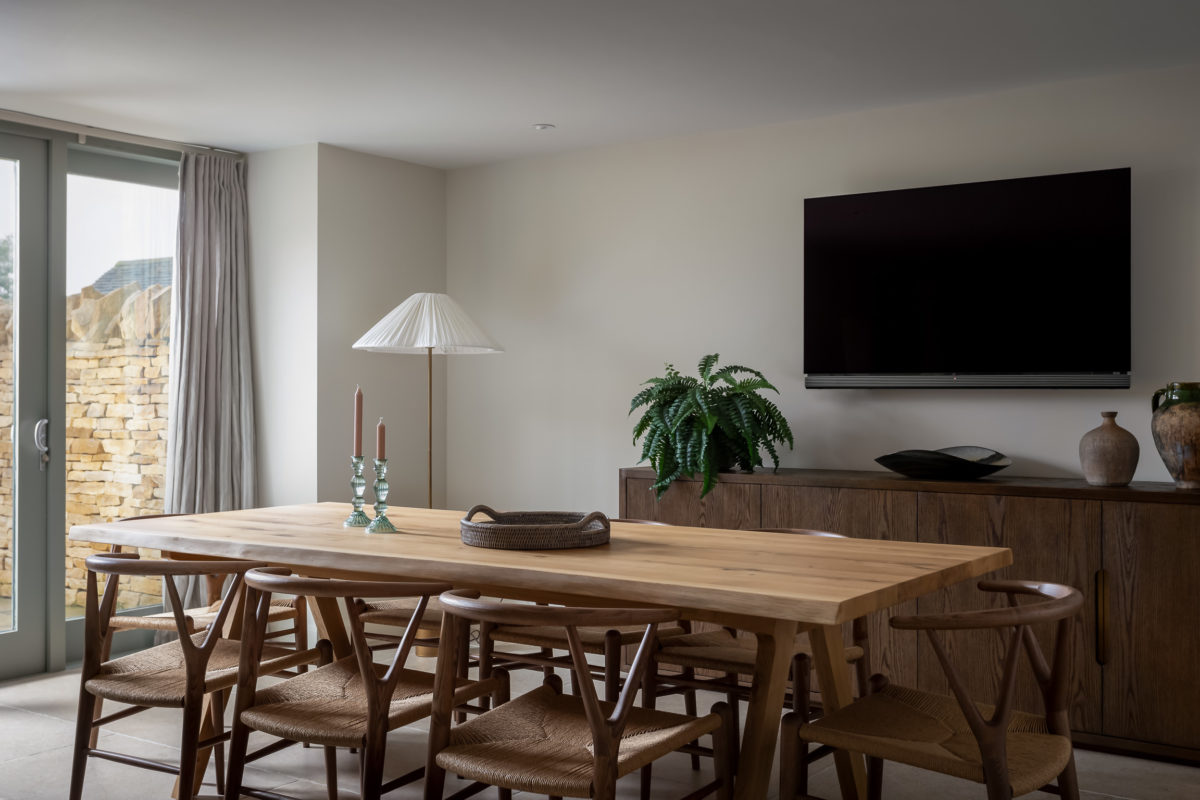 Oak dining table, ash & wicker dining chairs, walnut sideboard with TV above. Floor lamp